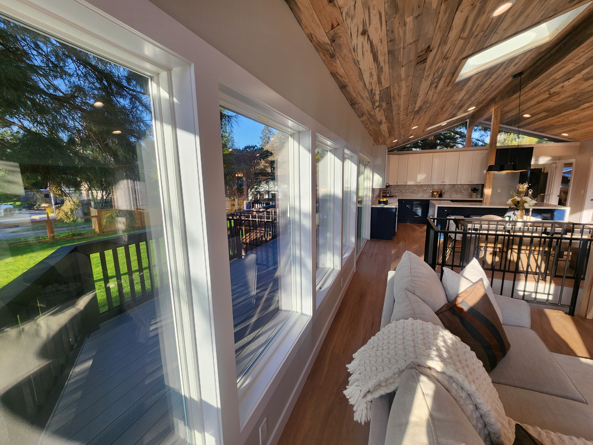 Remodeled kitchen and living space with large windows in a Maple Valley home